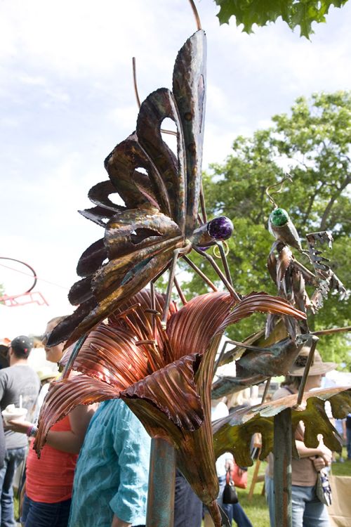 The image is of a butterfly garden statue at the Flint art fair. 