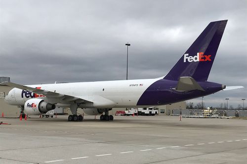 The image is of FedEx planes parked at the airport.