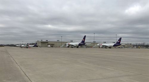 The image is of FedEx planes parked at the airport. 